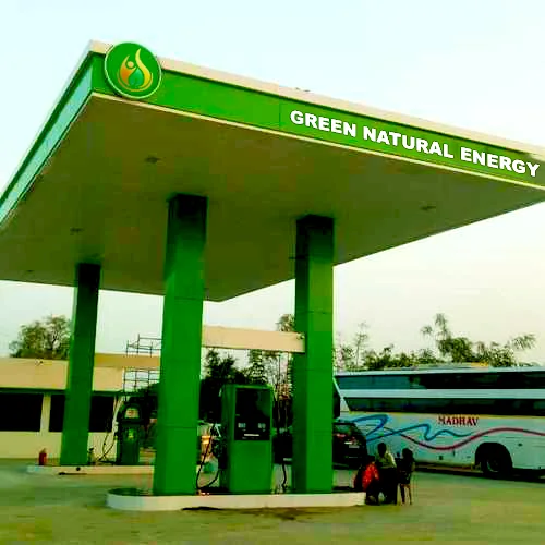 A Green Natural Energy fuel station with green canopy and pumps